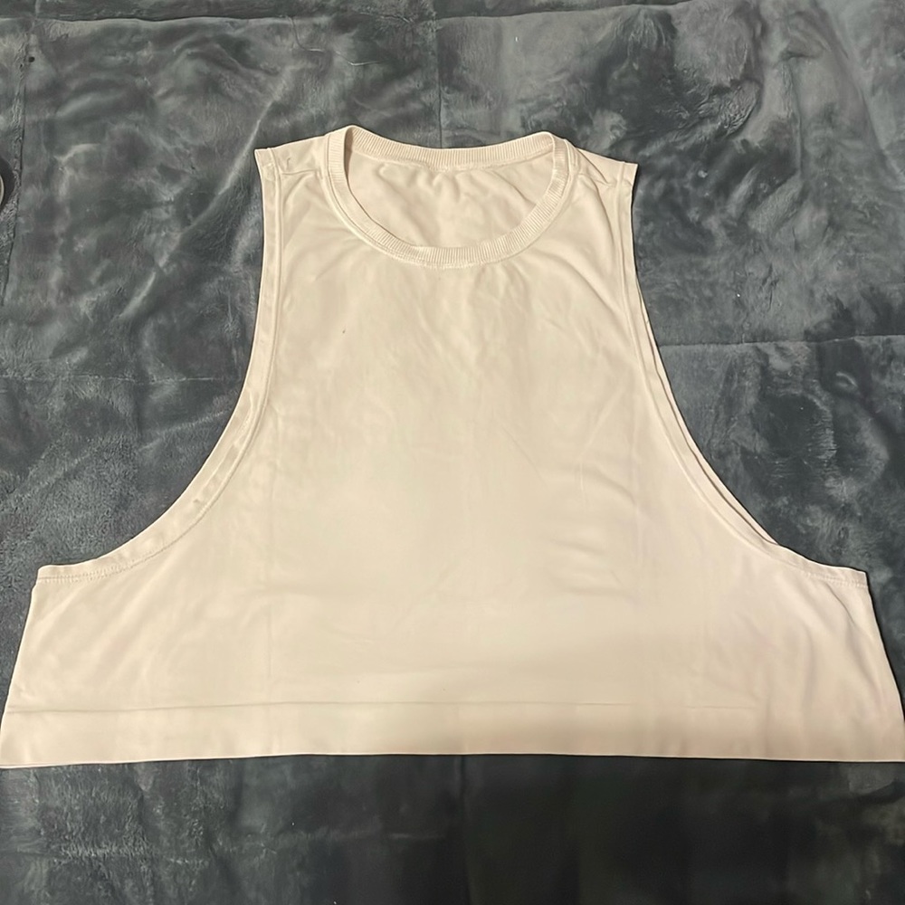 This is a tan avacodo tank shirt it is a median or small and almost brand new